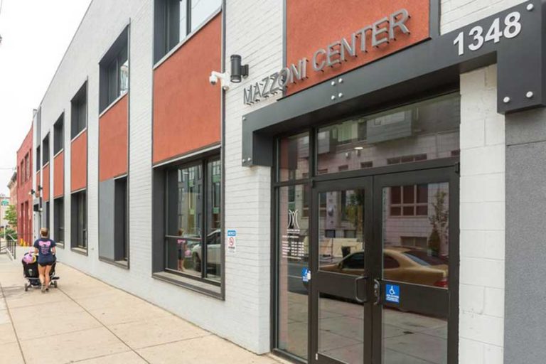 Mazzoni Center, a brick building with black and white accents.