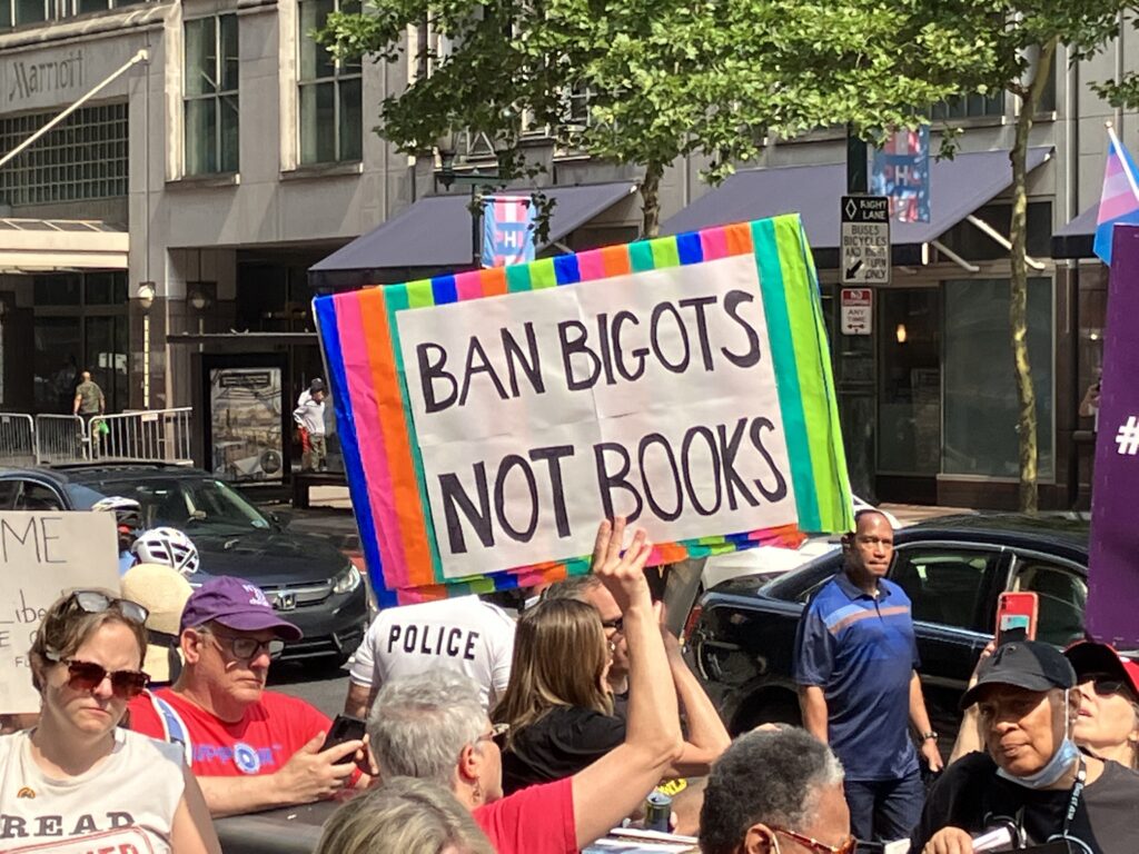 "Ban bigots not books" Moms for Liberty protest sign