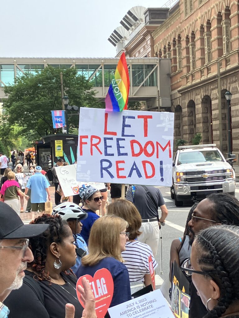 Moms for Liberty protest sign reading, "Let Freedom Read"