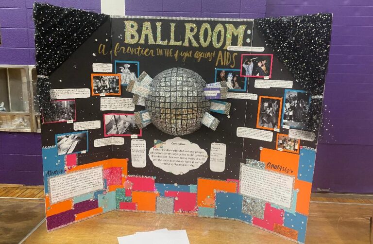 A half disco ball attached to a poster entitled “Ballroom: A Frontier in the Fight Against AIDS