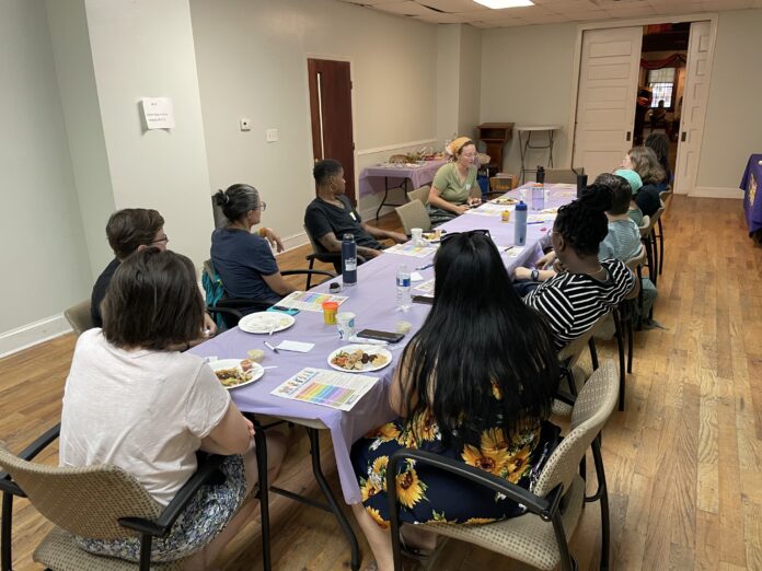 Philadelphia Family Pride Paths to Parenthood workshop, where prospective LGBTQ+ parents are sitting around a table.