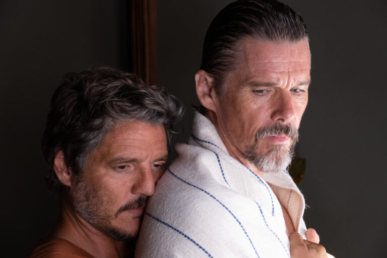 Silva (Pedro Pascal) hugs Jake (Ethan Hawke) from behind in a still from 'Strange Way of Life.'
