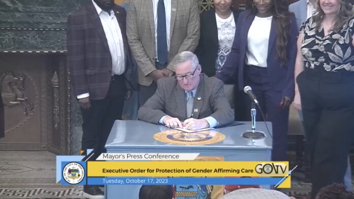 Philadelphia Mayor Jim Kenney signs an executive order protecting trans and gender-expansive individuals seeking gender-affirming care in the city. (Screenshot: City of Philadelphia Government Facebook page)