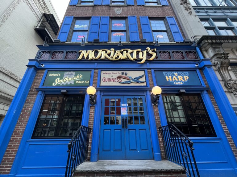An historic building painted blue with a sign reading Moriarty's above the front door.