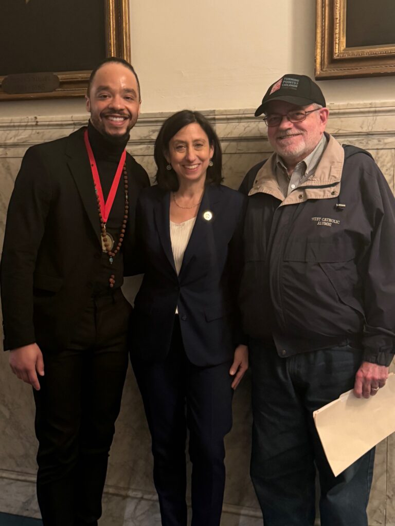 Councilmember Rue Landau stands with David Fair and D'Angelo D'Ontace Keyes — all LGBTQ+ leaders who knew and worked with Michael Hinson — after a recent city council meeting. Michael Hinson will soon have a street named after him called Michael Hinson Way.