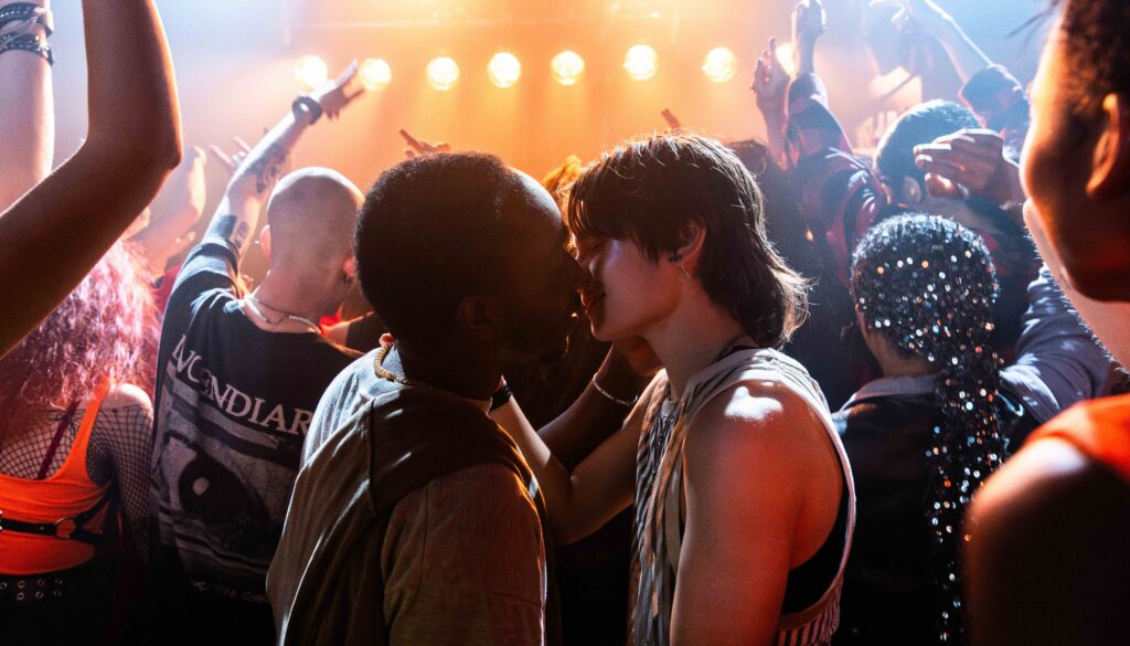Jerome Scott and Max Thomas in a scene from ‘We Collide.’ The two are kissing at a party.