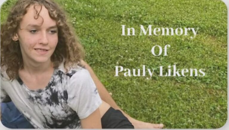 A photo of Pauly Likens sitting in the grass. Text says 