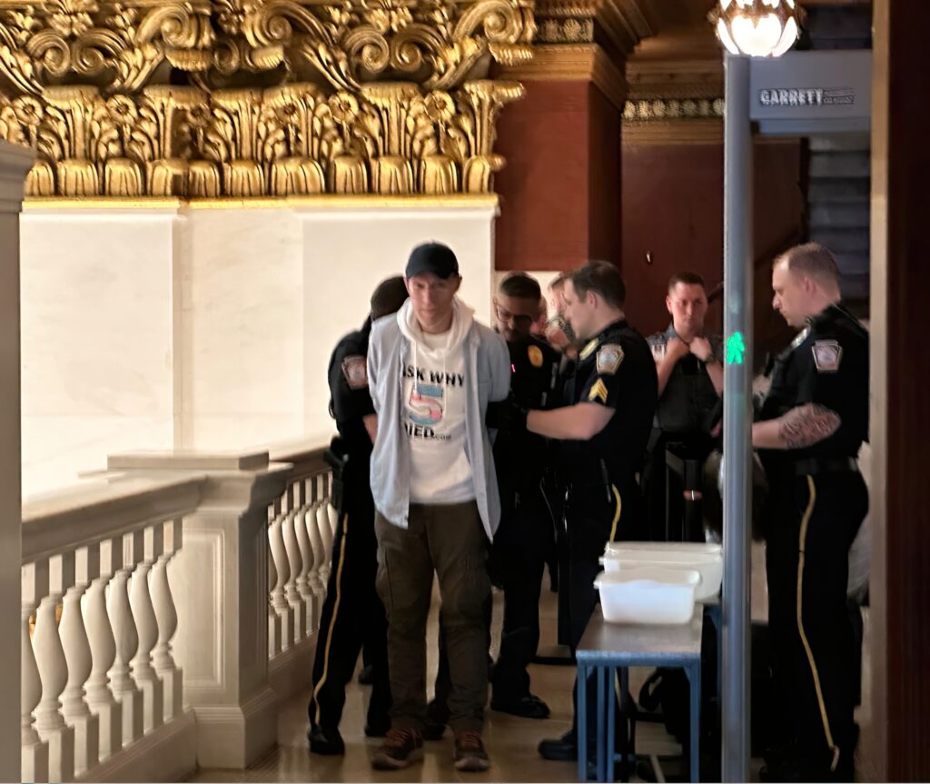 James M. Lantz gets arrested and is escorted by police.