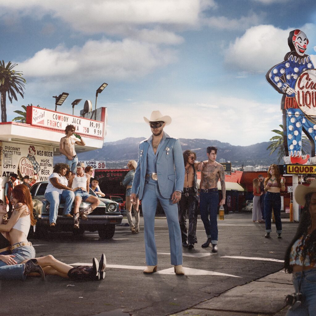 Orville Peck stands among people at a fair.