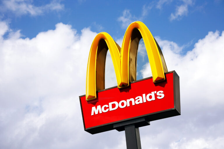 LONDON - JUNE 22: McDonalds logo on blue sky background on June 22, 2012, London, UK. It is the world's largest fast food chain, over 31,000 restaurants worldwide, serve 58 million customers each day