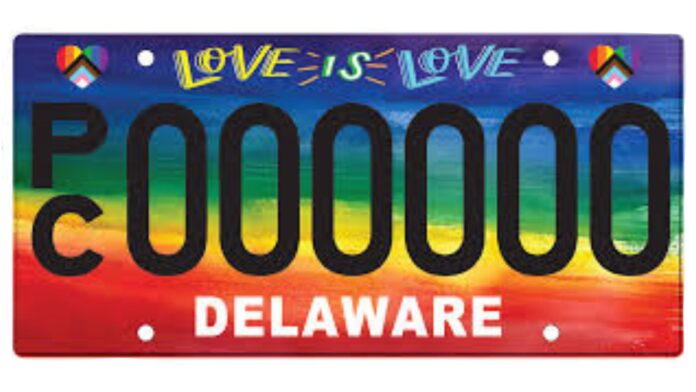 Delaware license plate with a rainbow background and the text 'Love is Love' at the top. The license plate features black characters 'PC 0000000' and the word 'Delaware' in white letters at the bottom. Heart-shaped symbols with rainbow colors appear in the top corners.