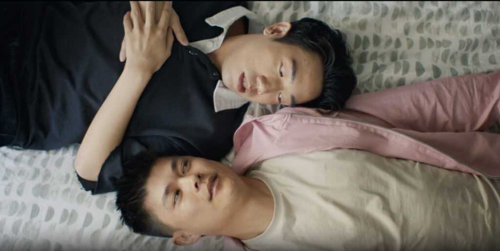 Ivan Leung (top) and Harrison Xu (bottom) lay down next to each other in ‘Extremely Unique Dynamic.’