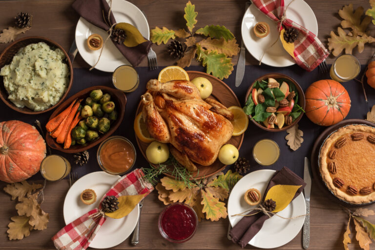 Thanksgiving Turkey Dinner with All the Sides. Homemade Roasted Turkey and all traditional dishes on Festive Thanksgiving table, top view.