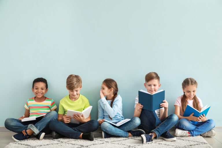 Children reading books on color background