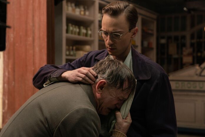 In a poignant moment from Queer, Allerton (Drew Starkey) embraces a distraught Lee (Daniel Craig) in a quiet, emotional scene that underscores the complexity of their relationship.