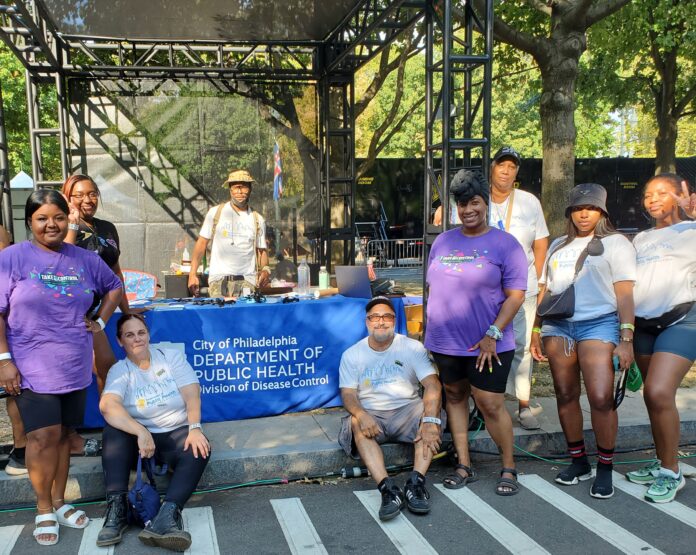 Department of Public Health volunteers pose for a photo at an event where they distributed free condoms.