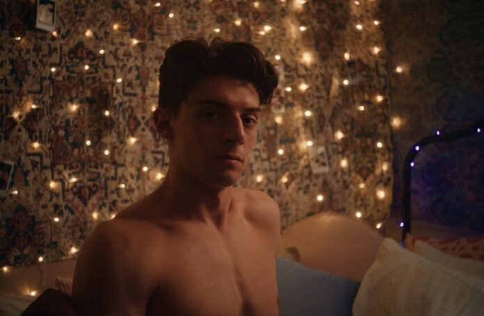 Liam Mollica stands shirtless in front of twinkling lights in ‘Sunflower’ film