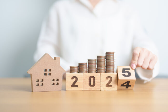 2024 end year to Happy New Year 2025 with house model and Coins stack. real estate, Home loan, tax, investment, mortgage, financial, savings and New Year Resolution concepts