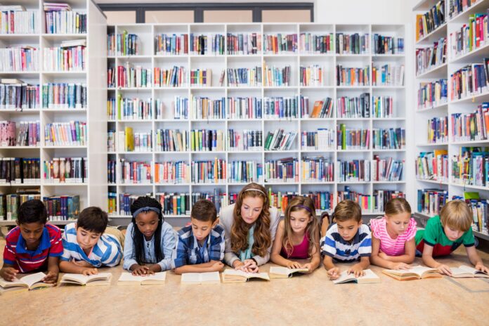 Teacher reading books to her students