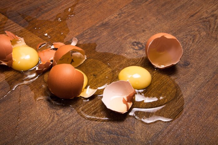 break eggs on the wooden floor