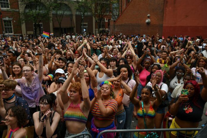 Attendees cheer and celebrate during Philadelphia Pride 2024 festivities.